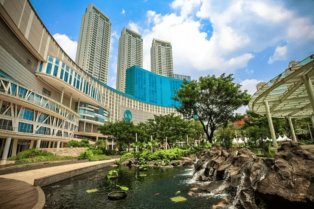 modern skyscrapers with a pond and rock waterfall