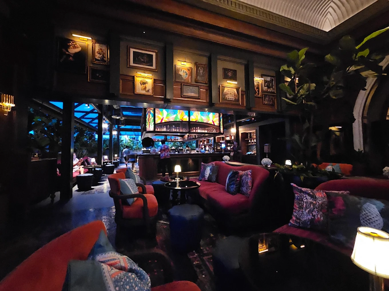 moody lounge bar with velvet sofas and wall art