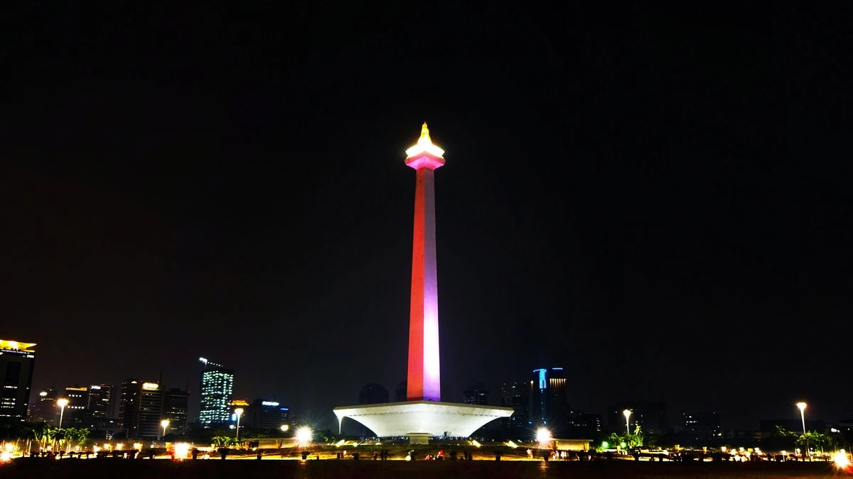 national monument monas illuminated in red and white at night