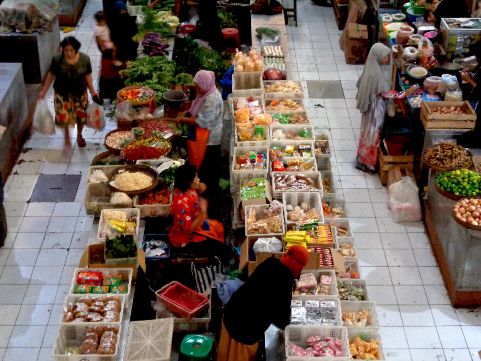 overhead view of vendors selling fresh produce and goods in a traditional market