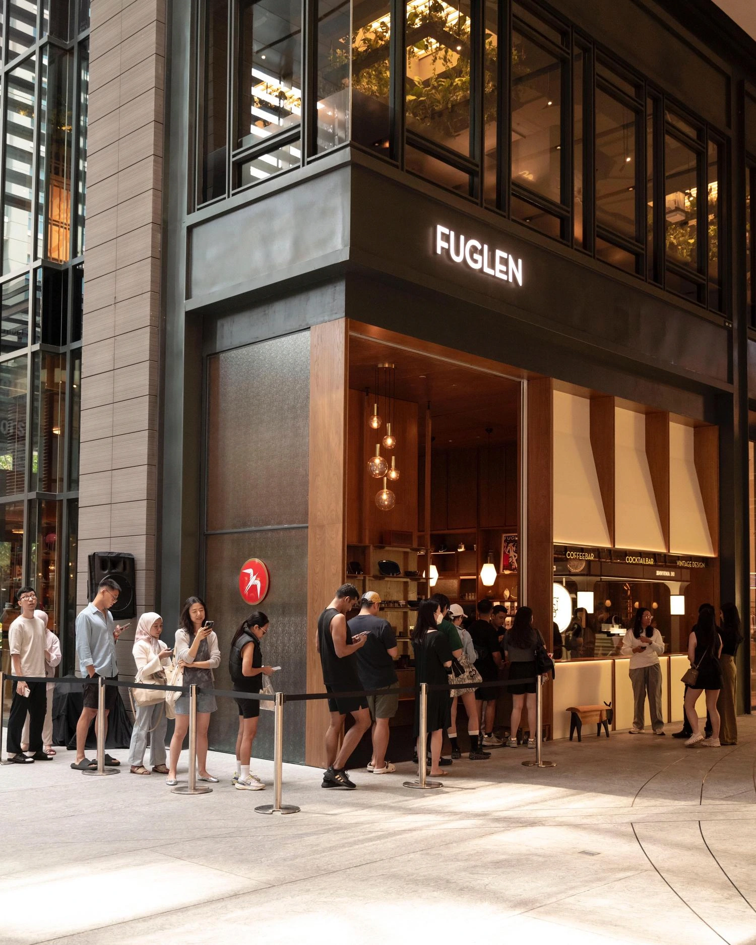 people lining up outside fuglen coffee shop storefront