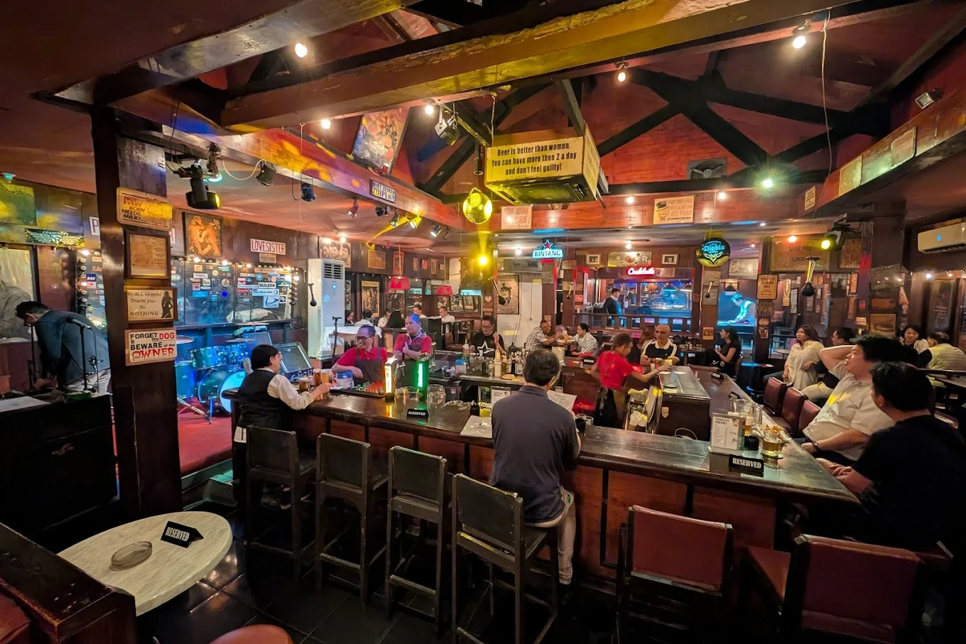 retro pub interior with central bar counter and live music stage setup