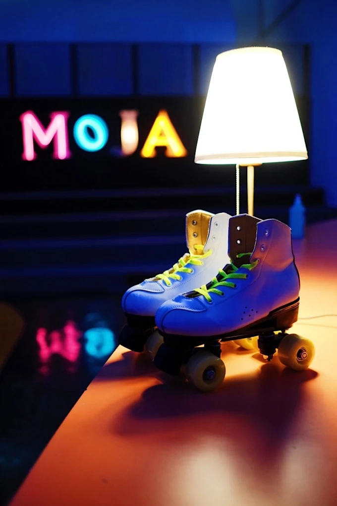 roller skates resting on a table under a lamp at moja museum
