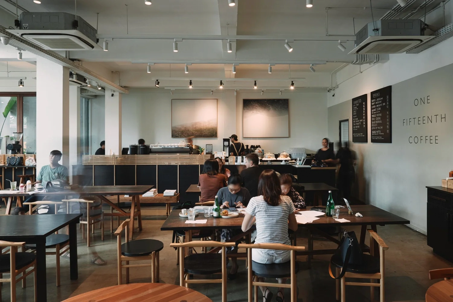 spacious cafe interior of one fifteenth coffee with customers sitting