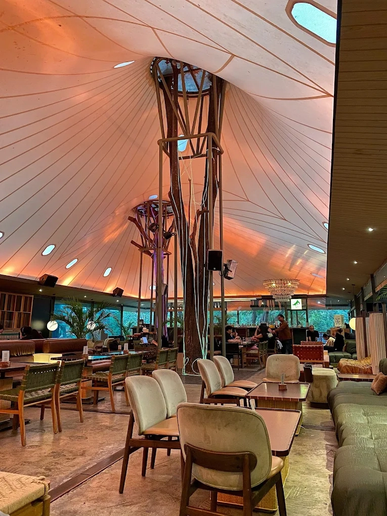 spacious lounge under a large canopy tent ceiling